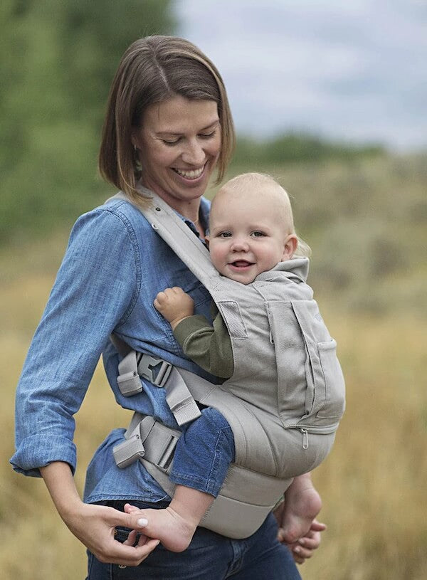 Mother carrying happy baby in an Onya Baby carrier